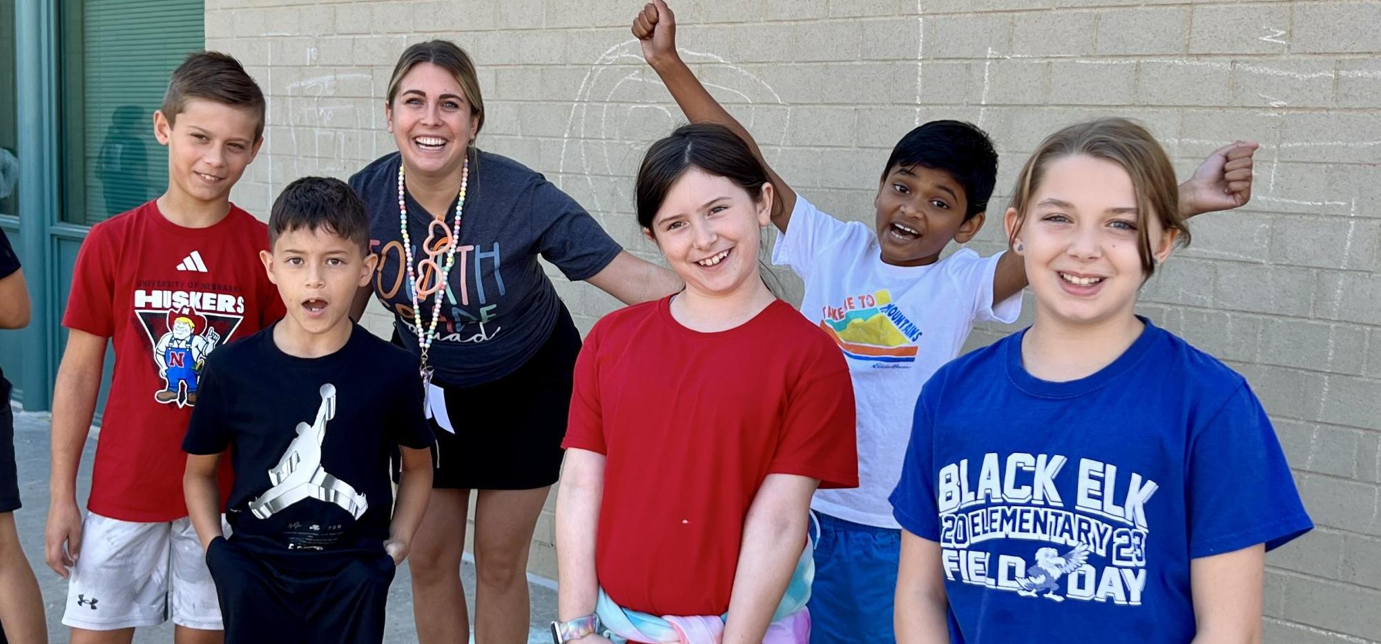 kids with teacher gathered outside