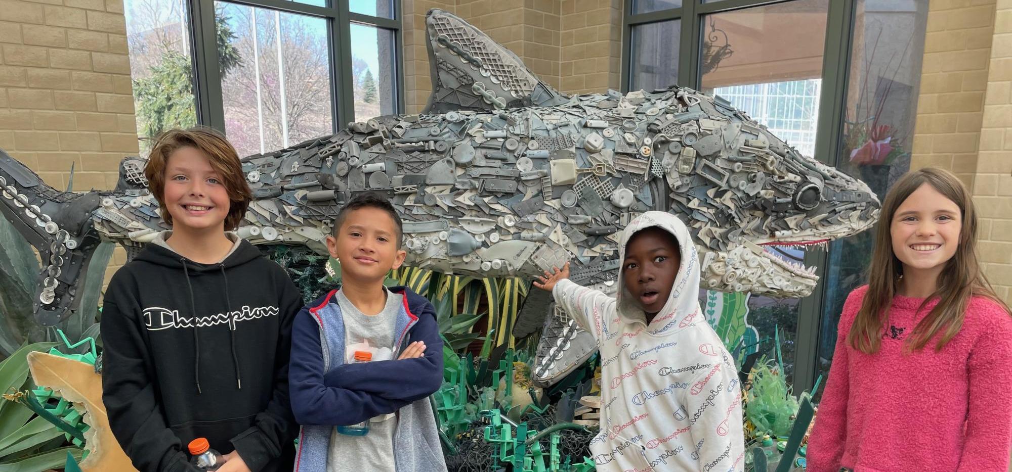 4 kids with recycled trash shark
