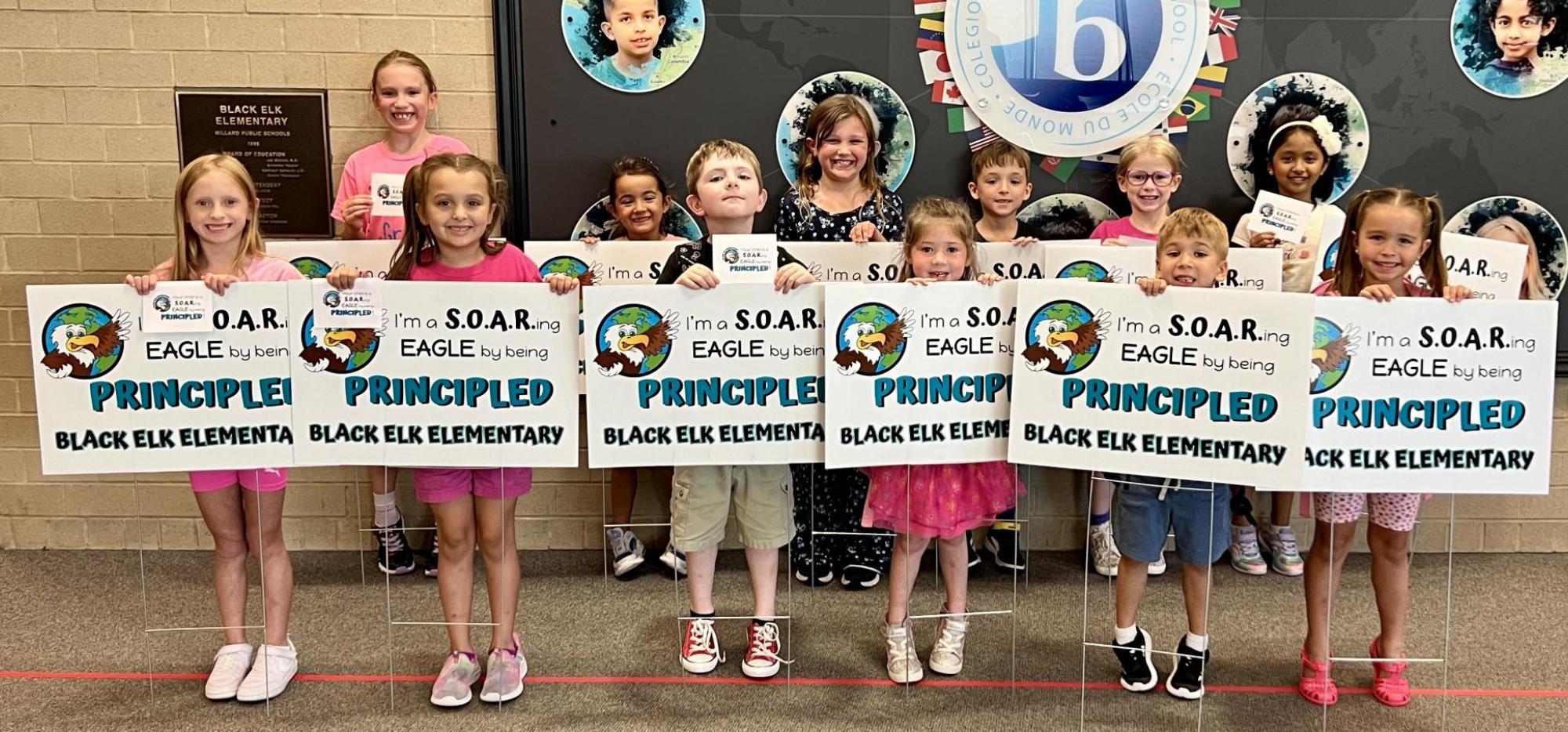 students holding principled signs